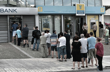 יוונים עומדים בתור לכספומט. הגבלה של 60 יורו ליום